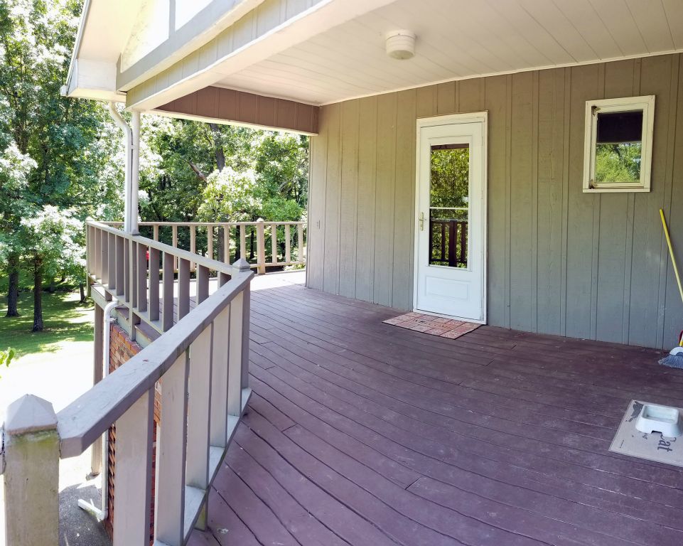 Covered Wood Deck Off Kitchen and Garage