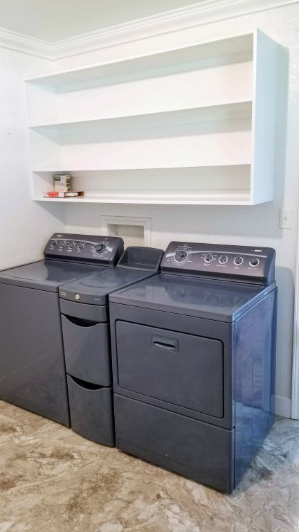 Washer & Drier with shelving above in Utility Room